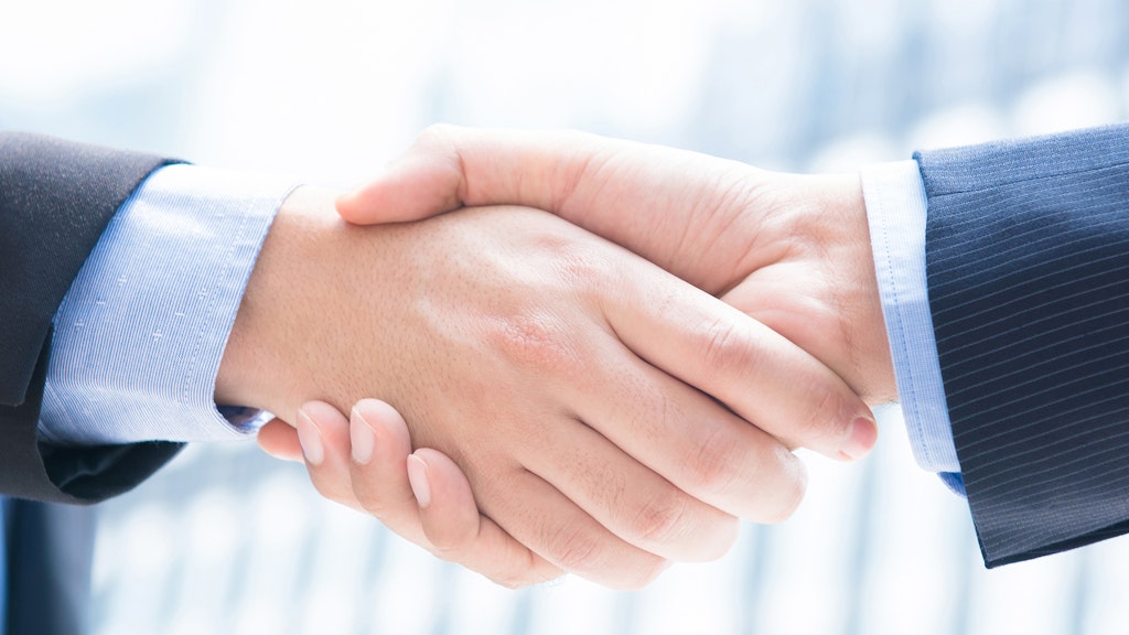 Close-up of a businessman's hands shaking hands, panorama banner