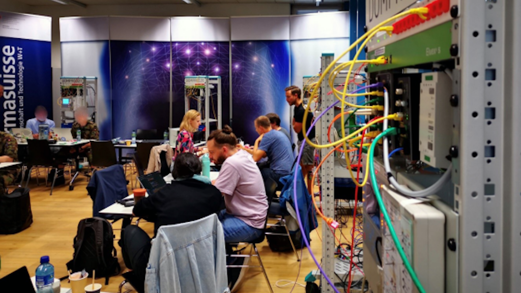 Cyber experts at work during the hackathon and a Krinflab device.