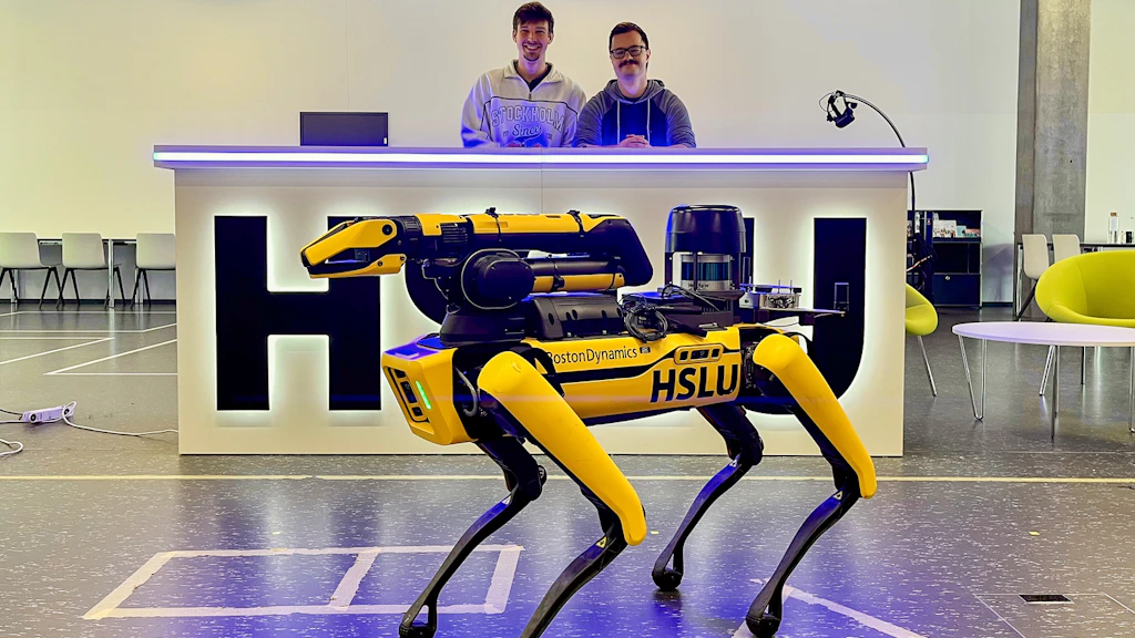 Group photo of Team BeBot with a four-legged walking robot