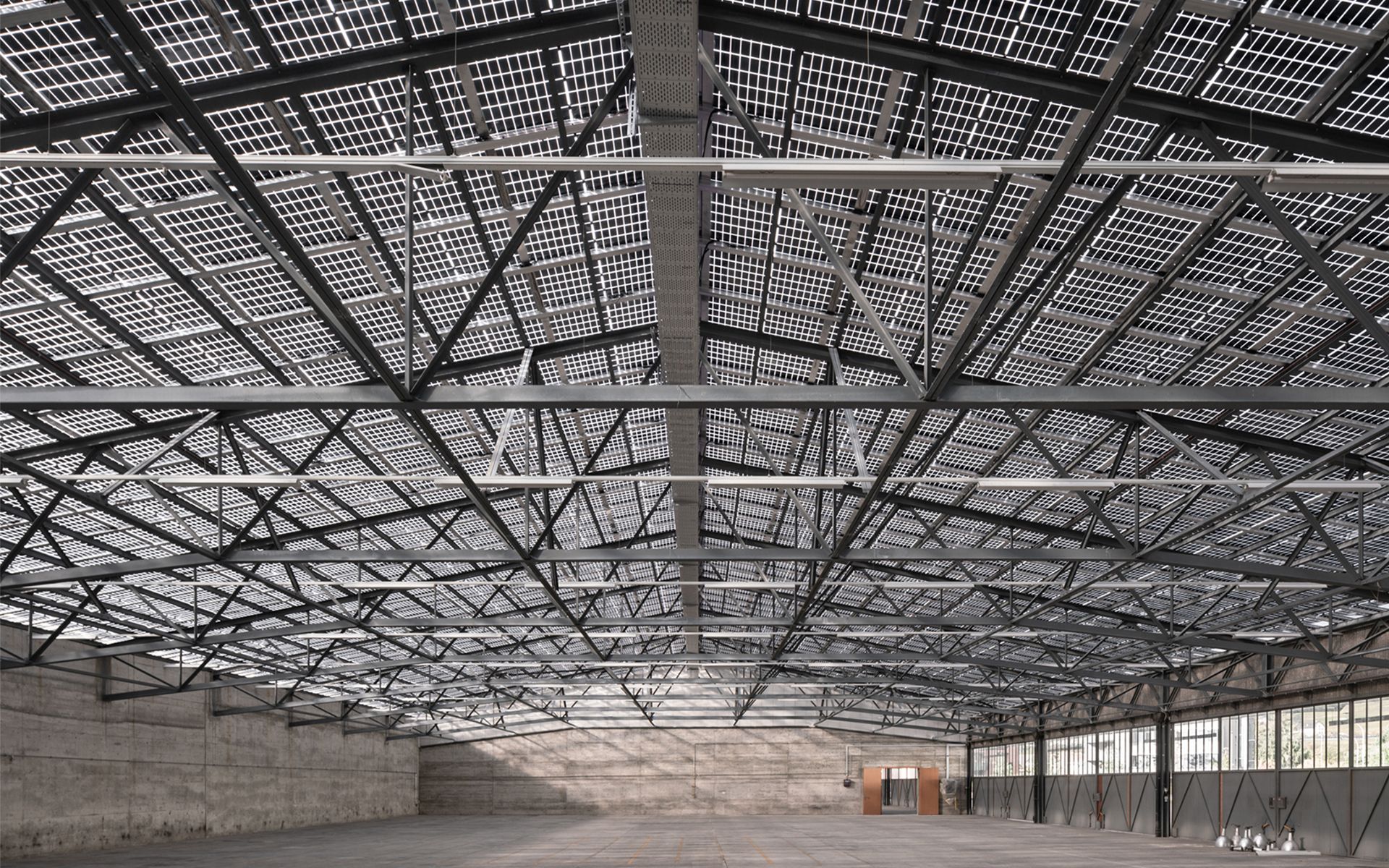 Durch die Verwendung halbtransparenter Photovoltaik-Module wird sichergestellt, dass eine ausreichende Menge an Sonnenlicht die Halle ausleuchtet.