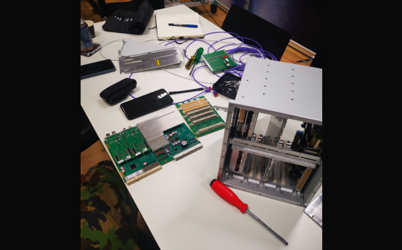 A disassembled computer stands on a table with various smartphones around it