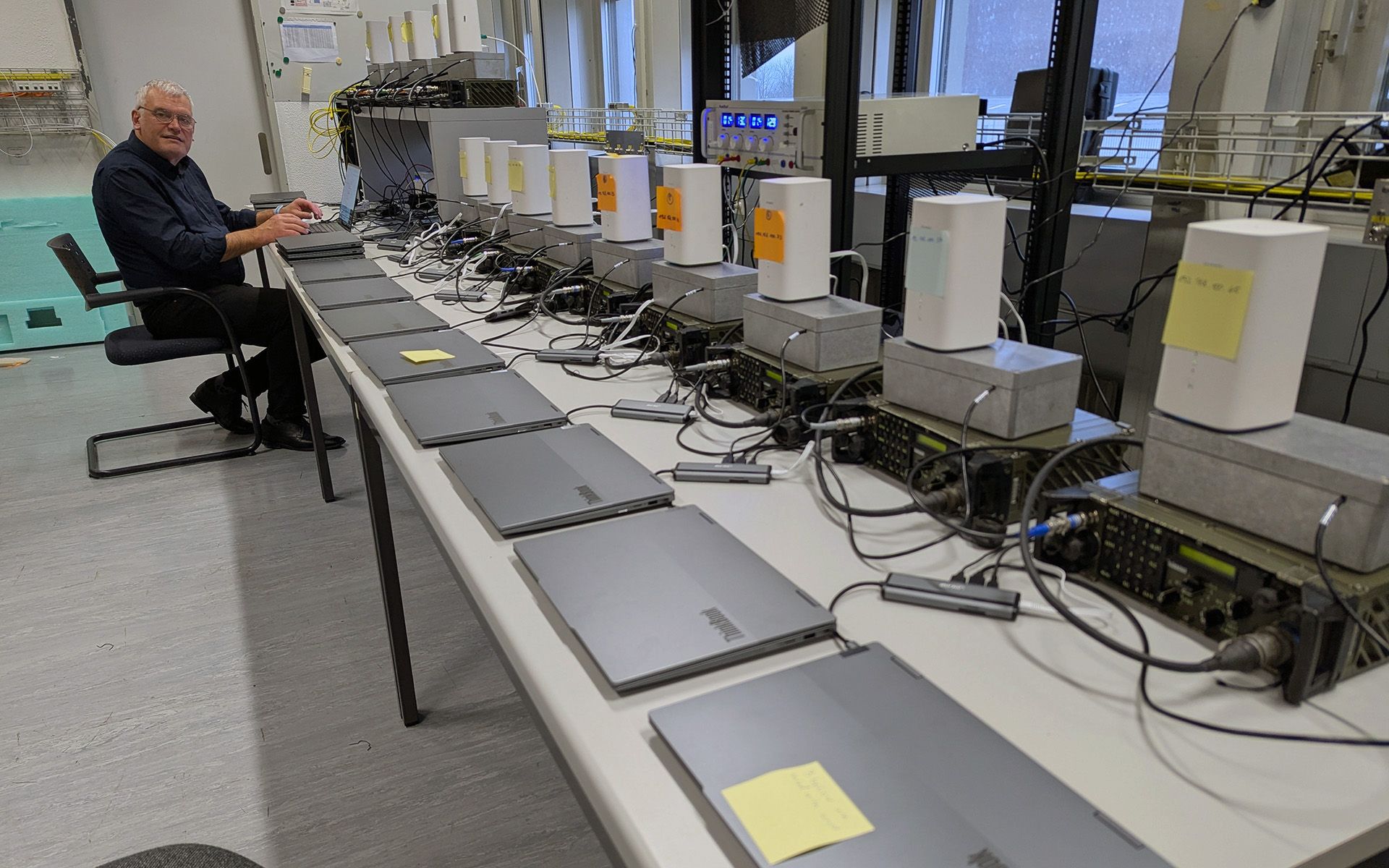 Long table, on which several computers and transceivers are wired. 