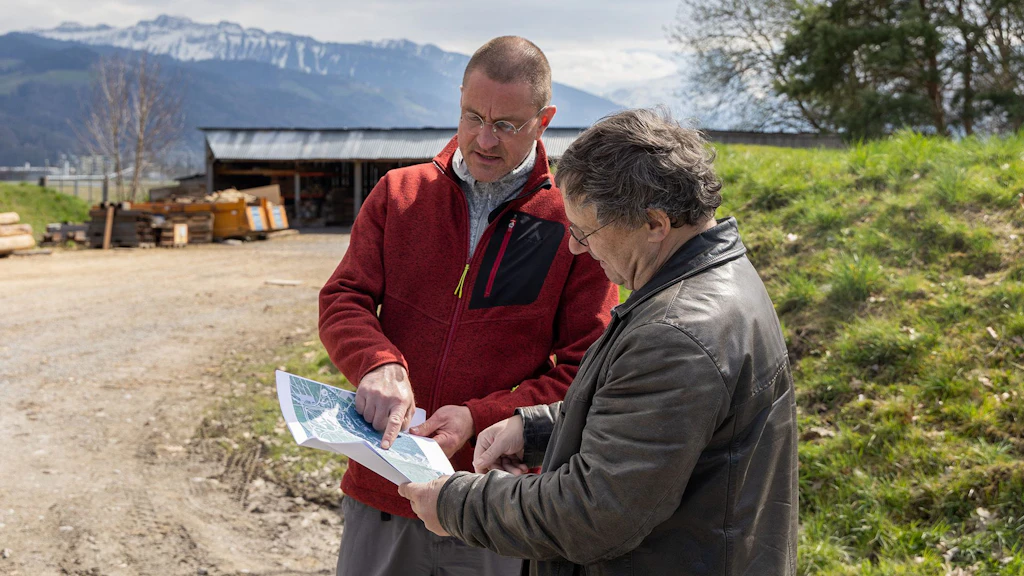 Frank Schneider is showing someone something on a map
