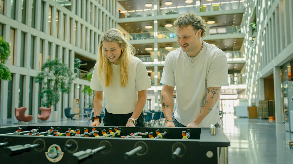 A man and a woman are playing table football.