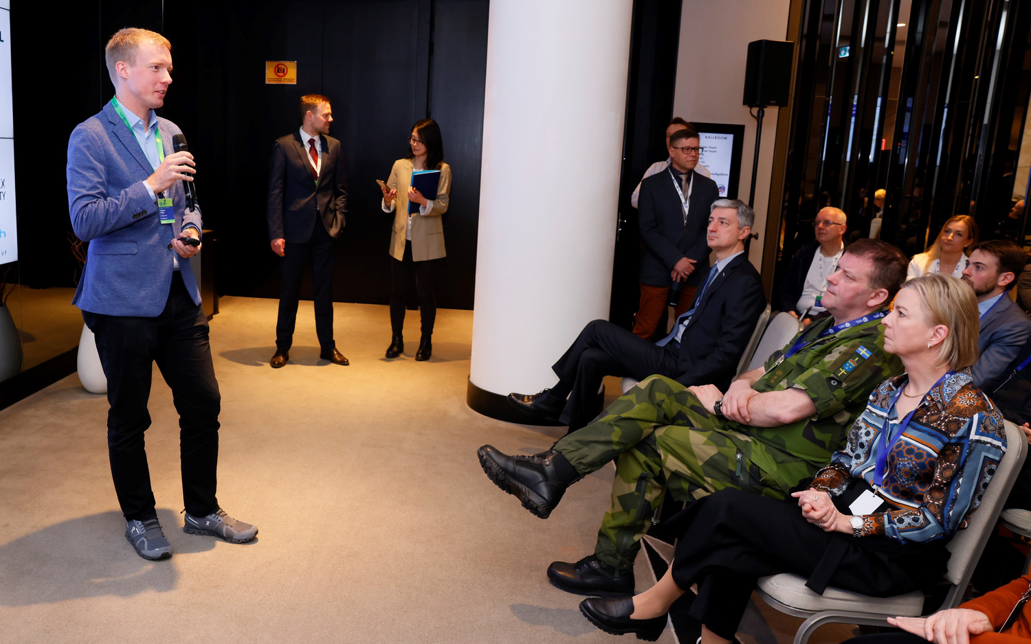 A man gives a lecture to several people.