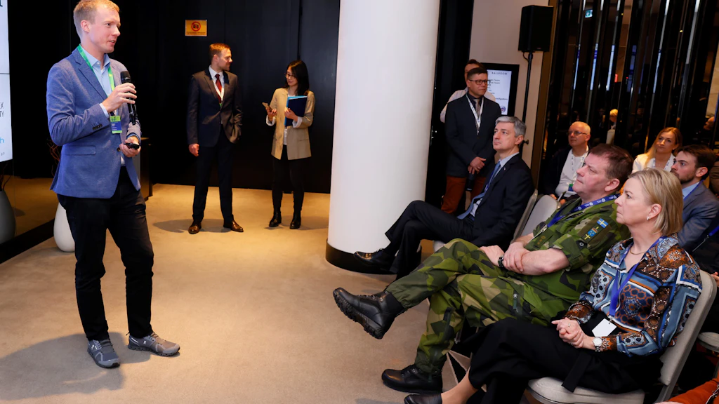A man gives a lecture to several people.