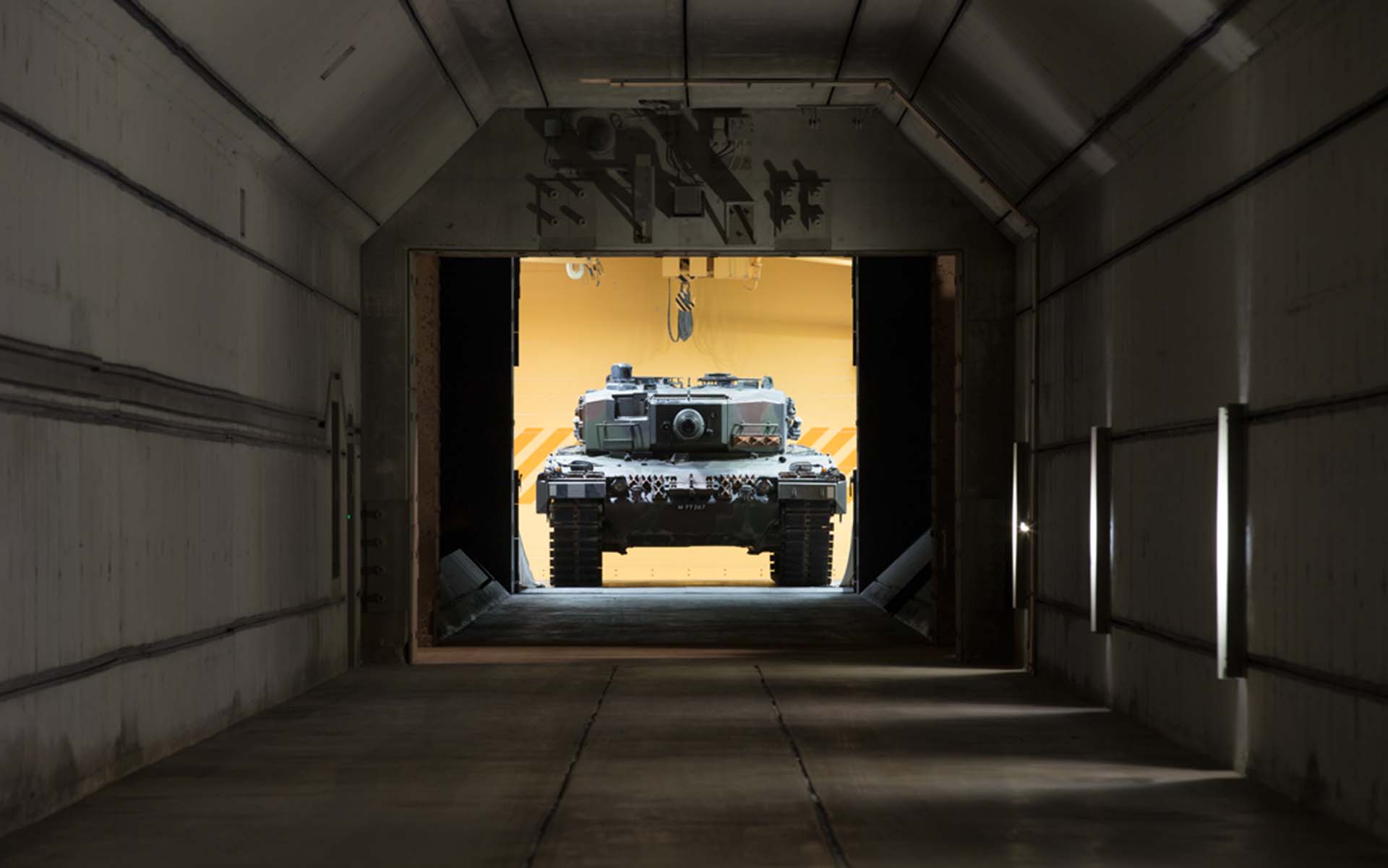 A tank stands in front of a shooting tunnel