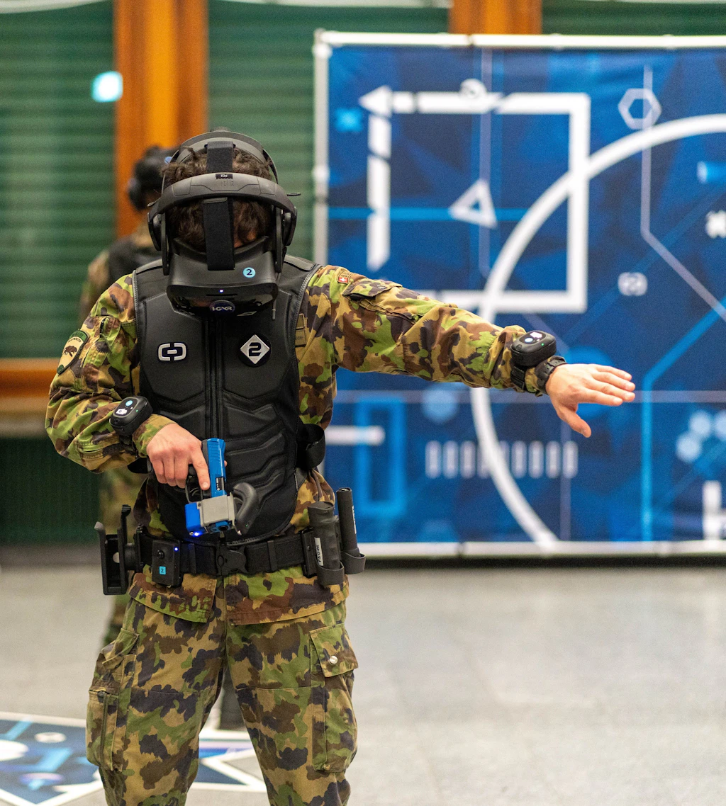 A soldier wearing virtual reality goggles practices complex missions in a virtual environment