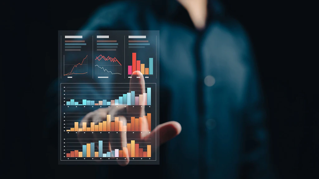 A man in a black shirt presses his finger on a digital, interactive statistic.
