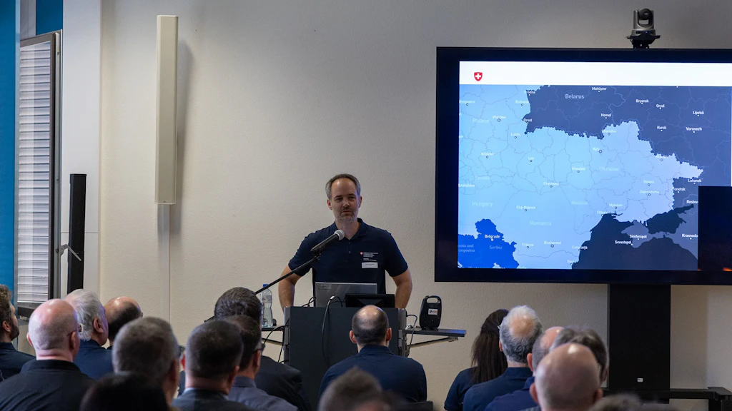 Dr. Chrisof Schüpbach presents the research program to the audience from behind the podium