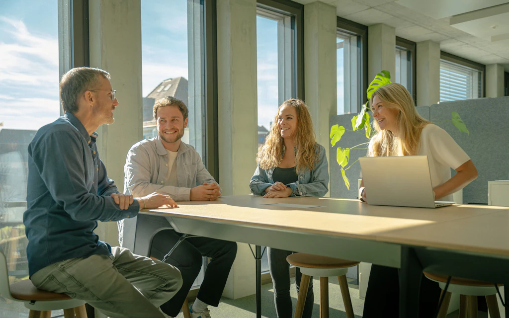Four colleagues in a meeting.