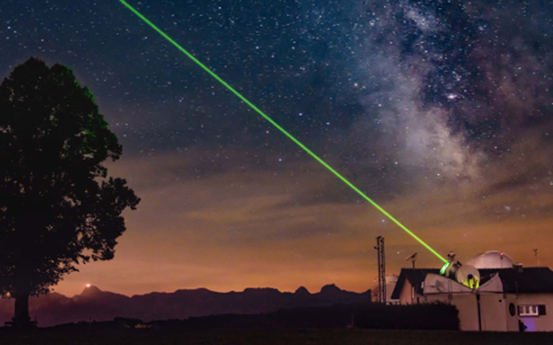 Observatory from which a green beam emerges into space