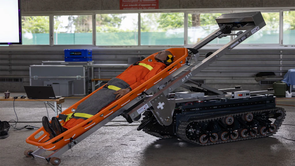 A robot is carrying a stretcher with a doll on it
