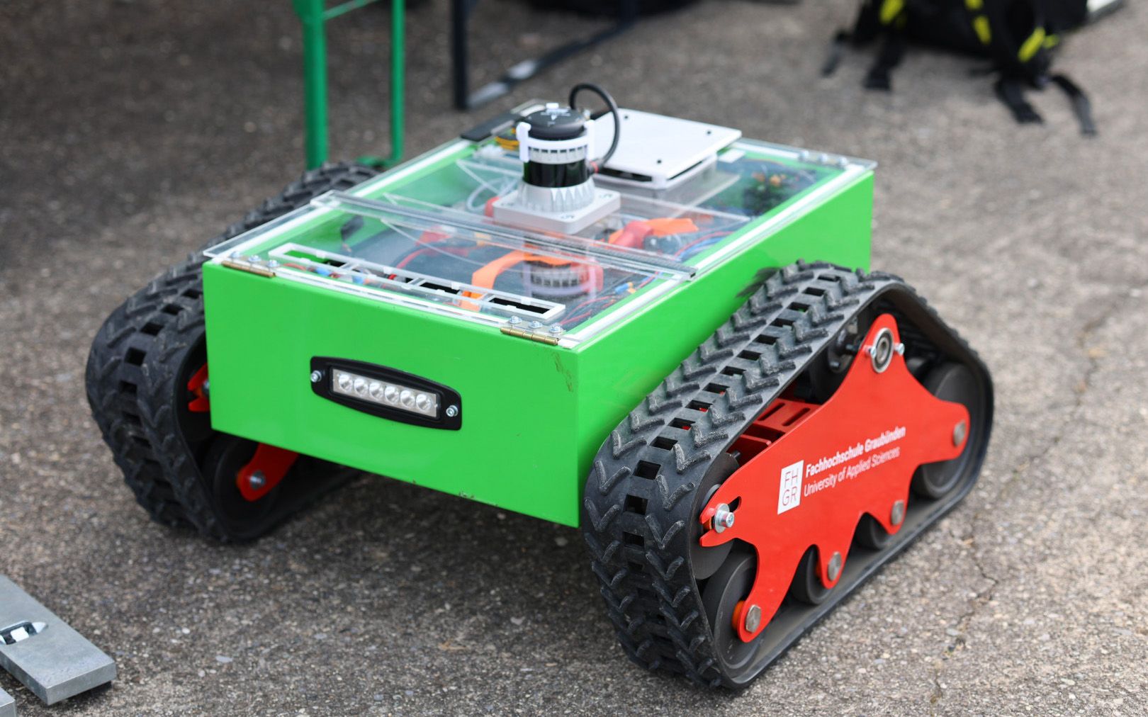 A green robot standing on the ground. 