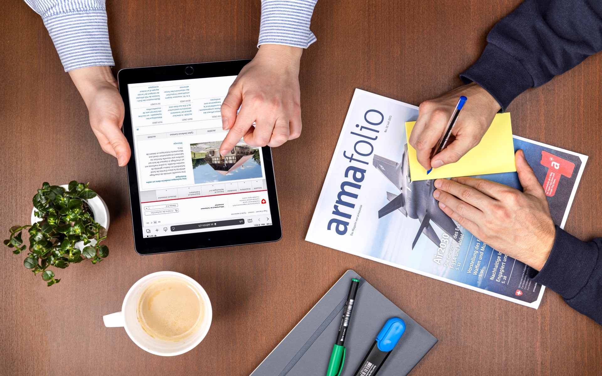 A bird's eye view of an office desk. On the table are various objects that are necessary for working in the office.
