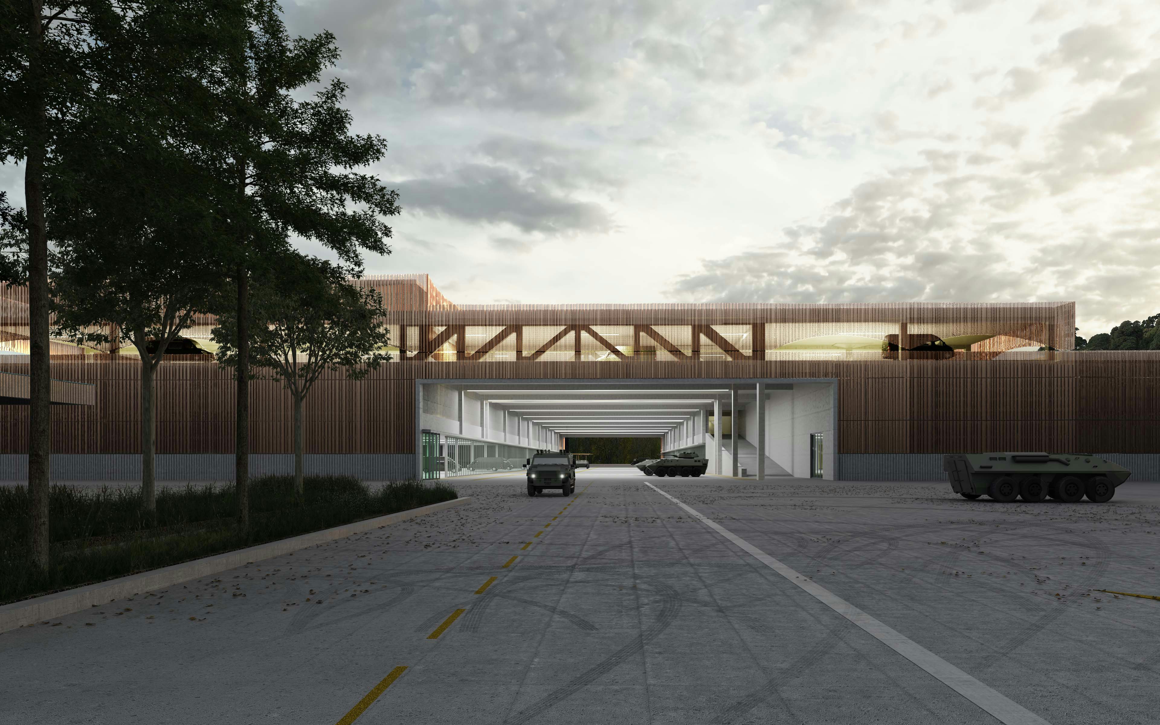 Vue du nouveau bâtiment logistique de stockage de véhicules militaires et de matériel. Le passage peut être utilisé en guise d’aire de préparation couverte.