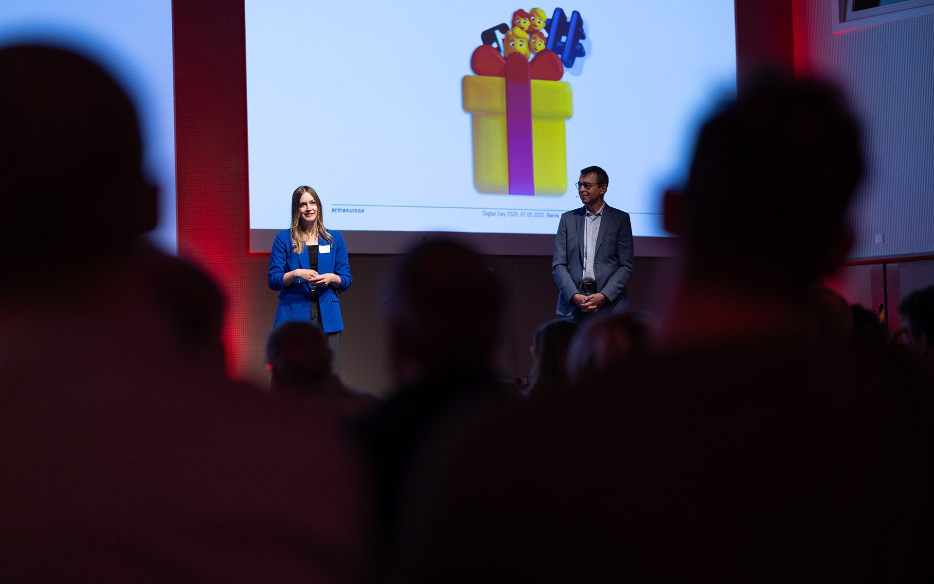 Laura Gross, social media manager di armasuisse e Kaj-Gunnar Sievert, responsabile Comunicazione di armasuisse tengono la loro presentazione sul tema Controllo centrale contro diffusione virale: l’interazione tra newsroom e social media